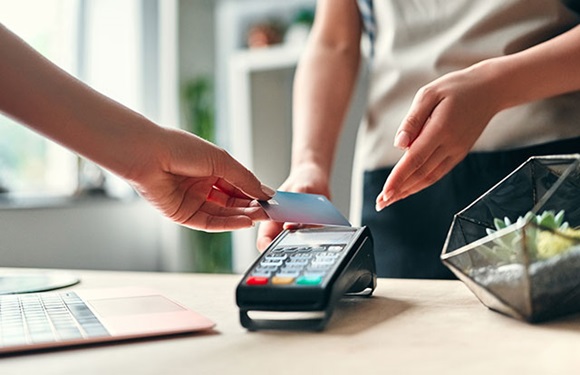 Customer paying a business using cashless payment solution Customer paying a business using cashless payment solution