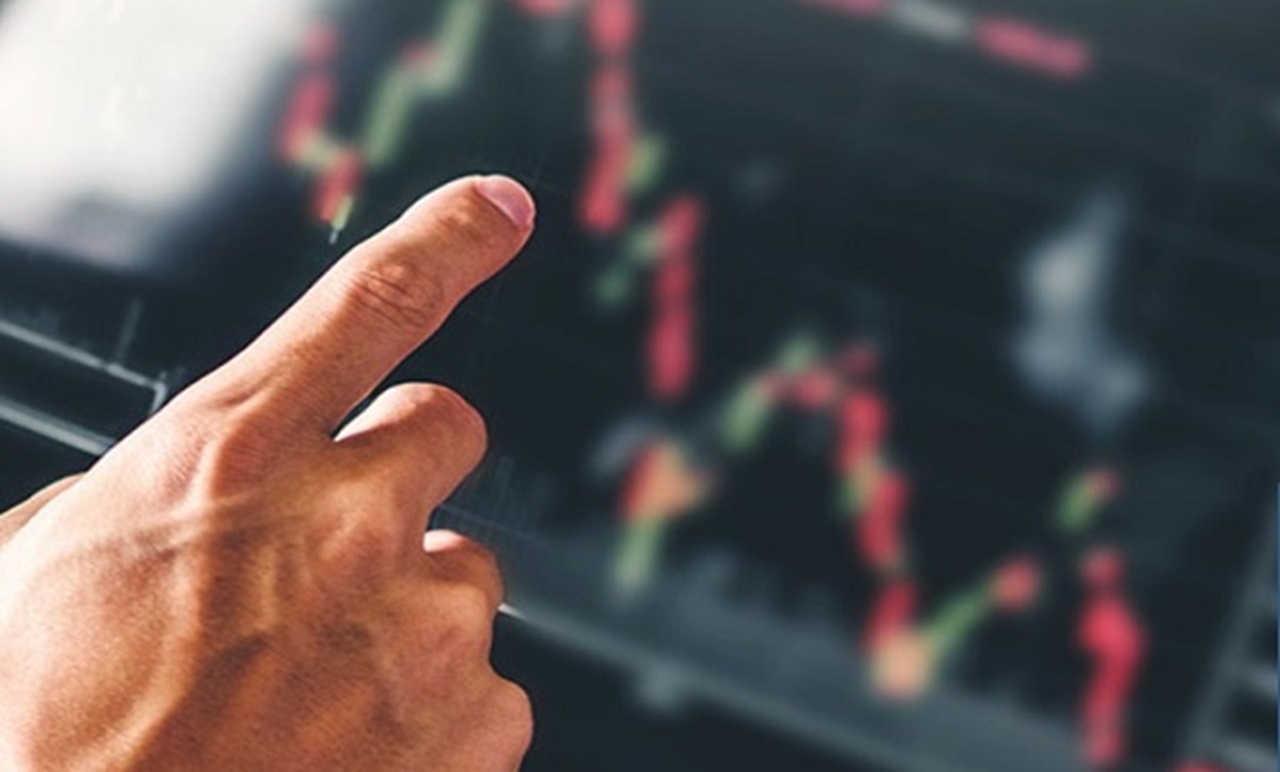 man tracking investment growths on his electronic device man tracking investment growths on his electronic device