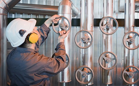 Man turning a valve Man turning a valve