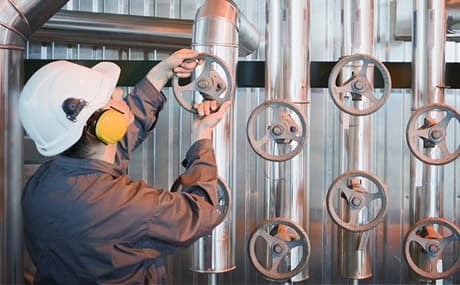 Man turning a valve Man turning a valve